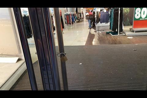 BHS Oxford Street security staff padlocked the doors for the last time as the final shoppers leave